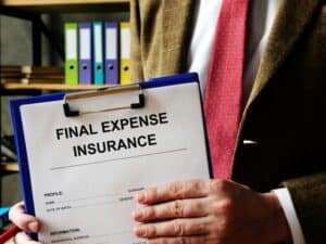 Final expense insurance agent holding clipboard with application for coverage